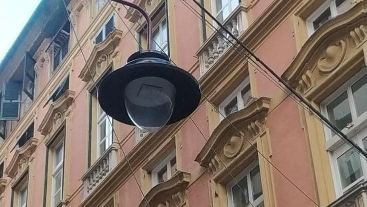 Cittadini rampanti a Genova: in centro storico lampioni in tilt, per segnalarli bisogna arrampicarsi