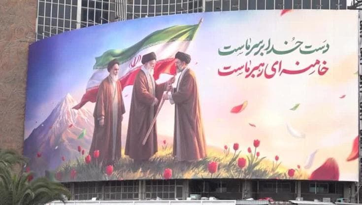 Nuovo murale a Teheran: Khomeini osserva, Ali Khamenei passa la bandiera dell'Iran al figlio Mojtaba