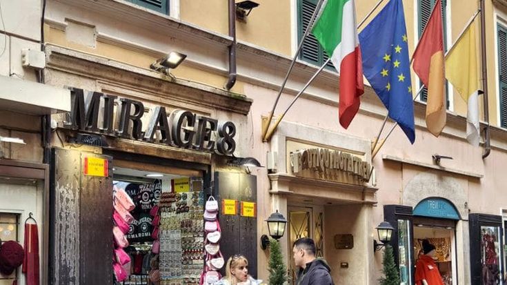 Bandiere, luci e fiori finti: tour a caratteri cubitali tra le targhe del centro storico