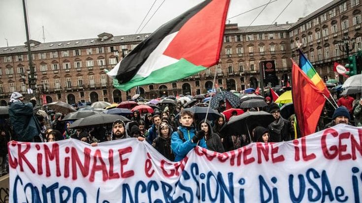 Corteo Pro Palestina a Torino sotto la pioggia, bandiera di Israele bruciata